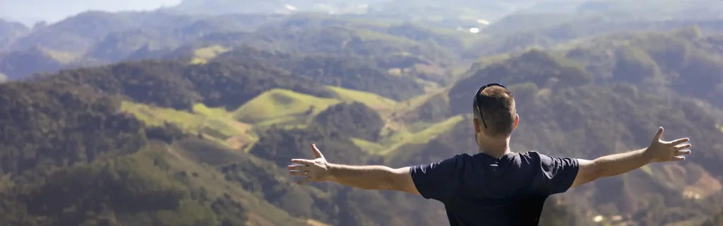 man-enjoys-quiet-moment-nature-standing-with-open-arms