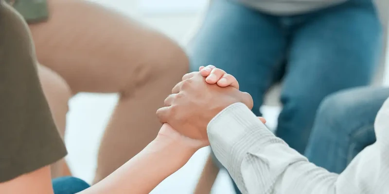 kembali group therapy child holding hand adult