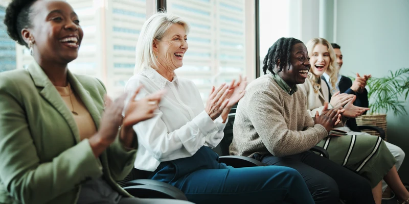 kembali group therapy three women clapping office