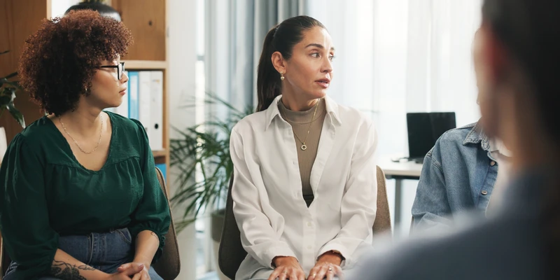 kembali group therapy three women sitting meeting room talking