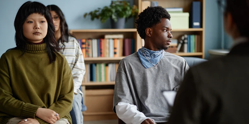 kembali group therapy two young women sitting room books