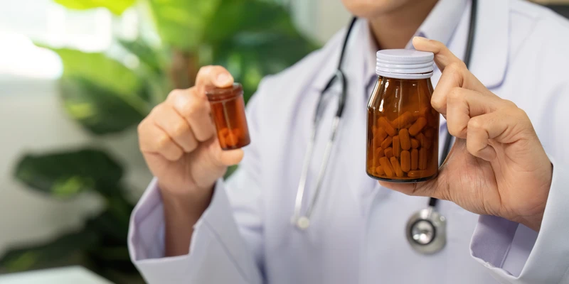 kembali prescription drug doctor holding bottle pills