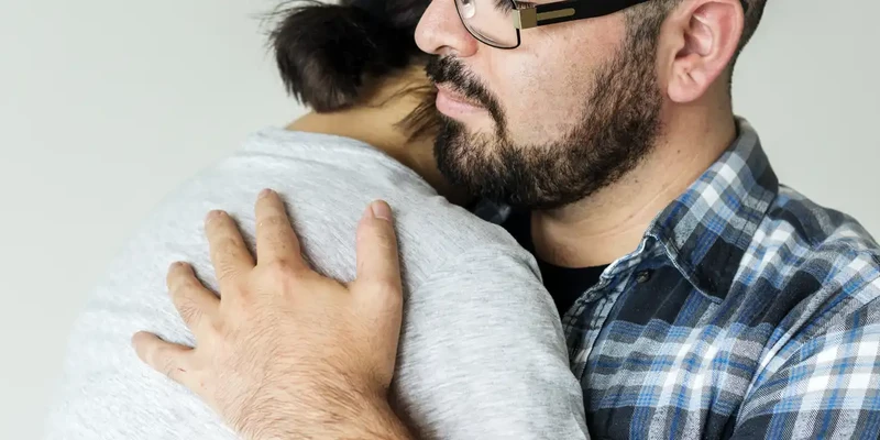 kembali therapy man glasses hugging dog