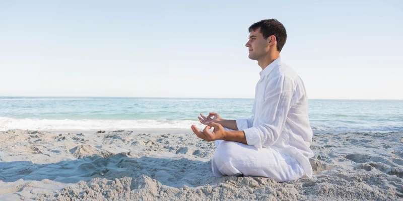 kembali yoga man meditating beach